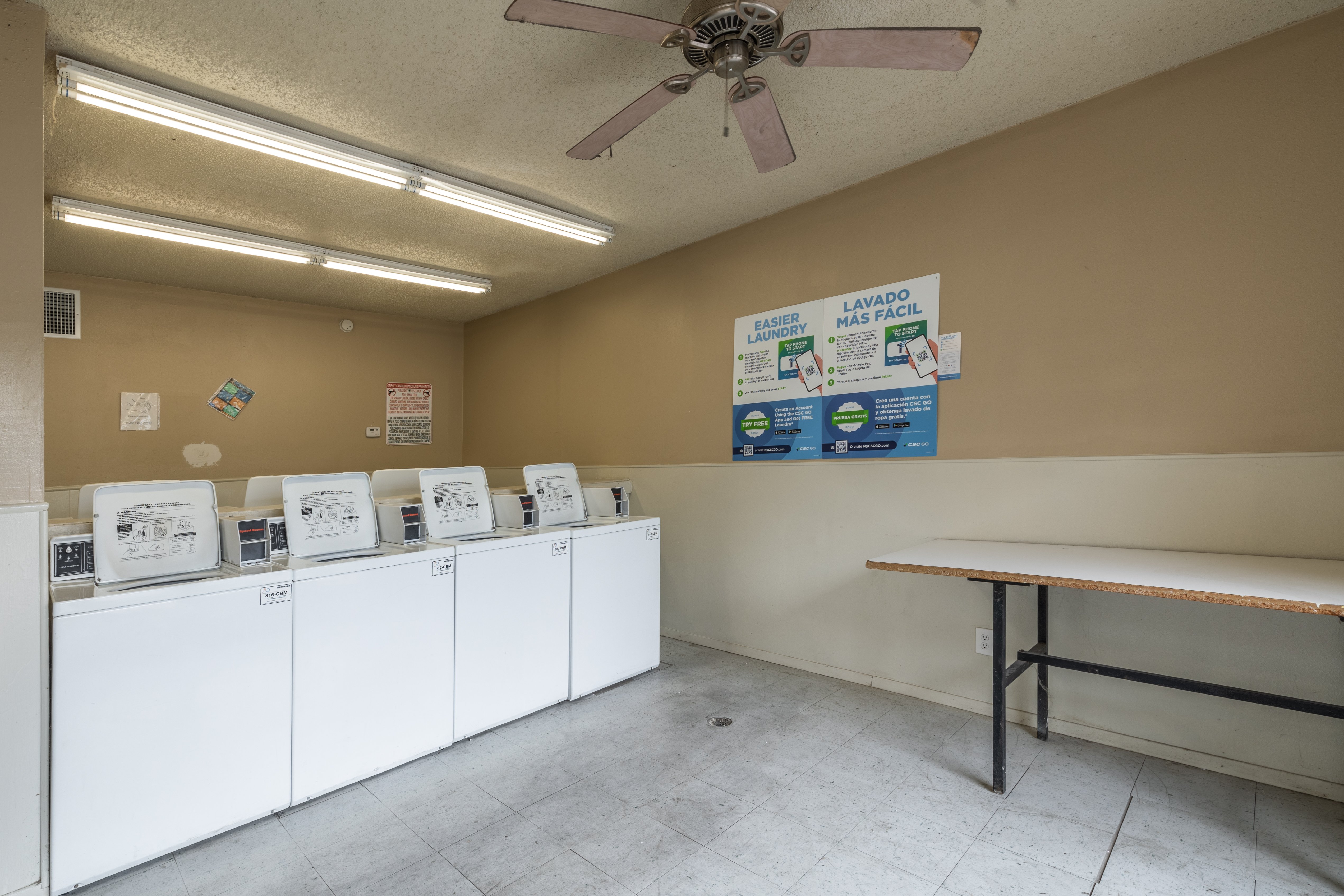 A room with a white table and a wall with a sign that says 